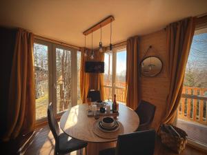 a dining room with a table and chairs and windows at Tiny house v Moravském Berouně in Moravský Beroun +22 photos