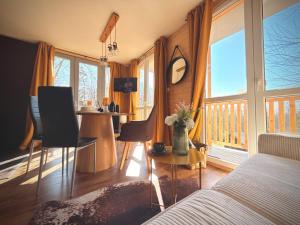 a bedroom with a bed and a table with chairs at Tiny house v Moravském Berouně in Moravský Beroun