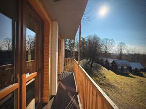 a balcony of a house with a view of a field at Tiny house v Moravském Berouně in Moravský Beroun