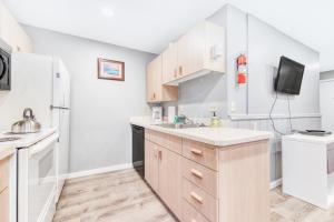 a kitchen with a sink and a refrigerator at Sea Treasures Inn Unit #212 in Rockaway Beach