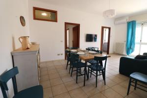 a dining room and living room with a table and chairs at Casa Giselle in Otranto in Otranto