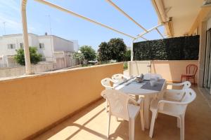 a patio with a table and chairs on a balcony at Casa Giselle in Otranto in Otranto