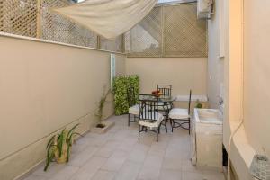 a small balcony with a table and chairs at Athenais Two Storey House in Zakynthos