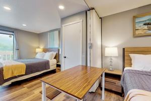 a hotel room with two beds and a table at Sea Treasures Inn #211 in Rockaway Beach