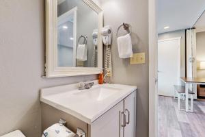 a bathroom with a white sink and a mirror at Sea Treasures Inn #211 in Rockaway Beach