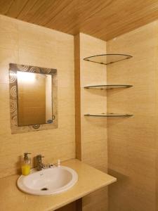 a bathroom with a sink and a mirror at Blueberry Residency - Hauz khas fort in New Delhi