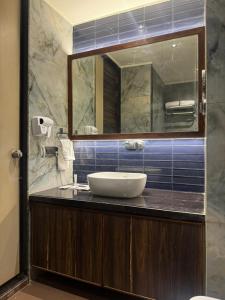 a bathroom with a sink and a mirror at Lords Swastik Studio Kodinar in Kodīnar +24 photos