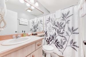 a bathroom with a toilet and a shower curtain at Sea Treasures Inn Unit #212 in Rockaway Beach