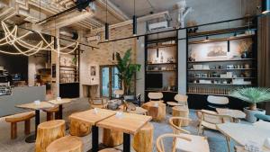 a restaurant with tables and chairs in a room at Pekanda apartment in Brno