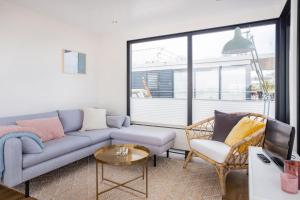 a living room with a couch and a chair at Welcome in - Houseboat Agua Dolce met tuin, Paviljoenwei 4, Sneek - Offingawier in Offingawier