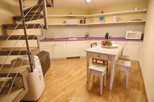 a kitchen with a table and chairs and a staircase at Rinidia Siena Centro in Siena +17 photos