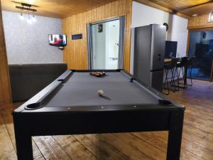 a pool table in the middle of a living room at Ô Chalet Normand in Colomby