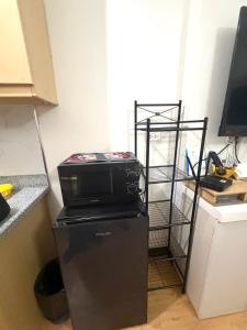 a microwave on top of a refrigerator in a kitchen at Compact Studio Unit At Mesaverte Residences in Pontud