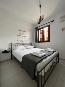 a bedroom with a bed with towels on it at Beachfront summer house in Derveni