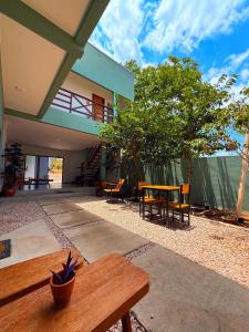 a patio with a wooden bench and a house at Ypê Hospedagem II in Sao Jorge