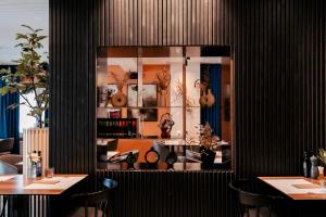 a restaurant with black walls and tables and mirrors at Hotel Restaurant Kod Barića in Grude