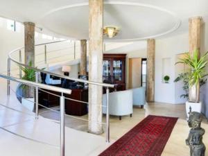 a lobby with a spiral staircase in a building at Grande Hotel in Vosburg +49 photos