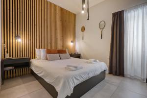a bedroom with a bed with towels on it at Stylish 1-Bedroom Apartment Just 5 Minutes from Valletta by Ferry in Mosta