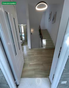 a hallway with a white door and a staircase at Farka Lake Luxury Villa in Tirana