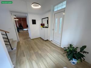 a hallway with a door and a potted plant at Farka Lake Luxury Villa in Tirana +56 photos