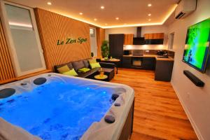 a large jacuzzi tub in the middle of a living room at ZEN SPA-4 Pers-Jacuzzi-Parking-Clim-Colmar in Colmar