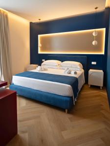 a bedroom with a large bed with blue walls at SetSail in Vibo Valentia Marina +46 photos