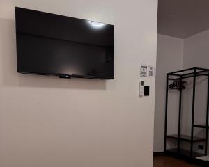 a flat screen tv hanging on a white wall at Balai de Biday 4 Pax Suite with Breakfast Option in Mameltac