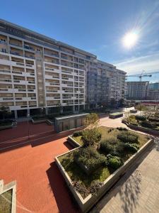 a large apartment building with trees in a courtyard at Apartman Ana Lux in Podgorica
