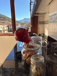 a kitchen counter with jars on a counter top at Itxinako Balkoia in Murueta-Orozko