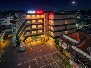 a building with a red sign on top of it at Gosyen Azana Hotel Salatiga in Salatiga