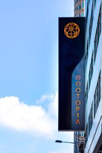 a sign for a hotel on the side of a building at Oootopia Kai Tak in Hong Kong