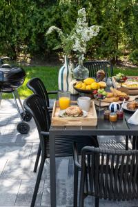 a black table with food on it with chairs at ZATORHOUSE in Zator