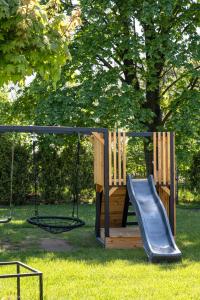 a playground with a slide and a swing at ZATORHOUSE in Zator +71 photos