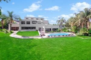 an exterior view of a house with a large yard at Fair Glen in Kyalami