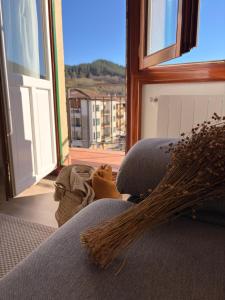 a room with a couch with a large window at Itxinako Balkoia in Murueta-Orozko