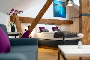 a bedroom with a bed with purple pillows at Hotel Zlaty Andel in Český Krumlov