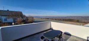a stool sitting on the balcony of a house at Neckartalblick in Nürtingen +14 photos