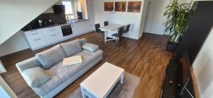 a living room with a couch and a table at Neckartalblick in Nürtingen