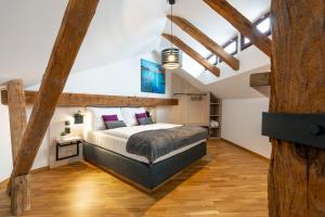 a bedroom with a bed in a room with wooden beams at Hotel Zlaty Andel in Český Krumlov