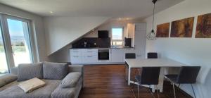 a living room with a couch and a table at Neckartalblick in Nürtingen