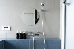 a bathroom with a shower with a blue sink at Kaitan稲佐の浜 in Taisha +17 photos
