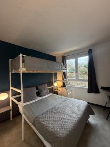 a bedroom with a bunk bed and a window at Hôtel La Nonette ASTERIX, CDG AIRPORT & PARIS CENTRE in Orry-la-Ville +100 photos