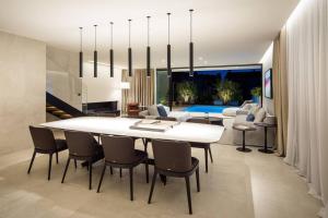 a dining room with a large white table and chairs at Z6 Dolcevita Signature - Villa & Private Yacht in the Heart of Rovinj in Rovinj