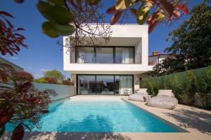 a house with a swimming pool in front of a house at Z6 Dolcevita Signature - Villa & Private Yacht in the Heart of Rovinj in Rovinj +57 photos