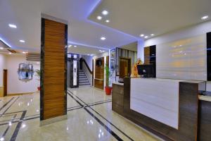 a lobby with a reception desk in a building at Hotel Mayur by RoomsInc Katra in Katra
