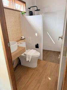 a bathroom with a toilet and a sink at Simada Resort&Cafe - สิมาดา สิชล in Ban Plai Thon