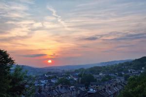 a view of a city with the sunset in the background at Chestnut Lodge in Bradford