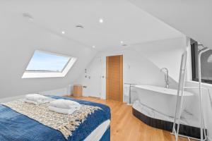 a bathroom with a bed and a tub and a sink at An Teallach in Balmullo