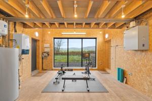 a gym with a treadmill in a room with a large window at An Teallach in Balmullo