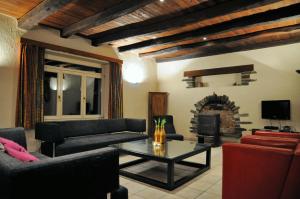a living room with a couch and a table and a fireplace at Moulin de Nawes in Herbeumont